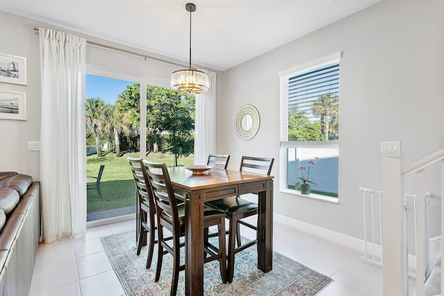 dining room featuring a wealth of natural light, a notable chandelier, and light tile patterned flooring