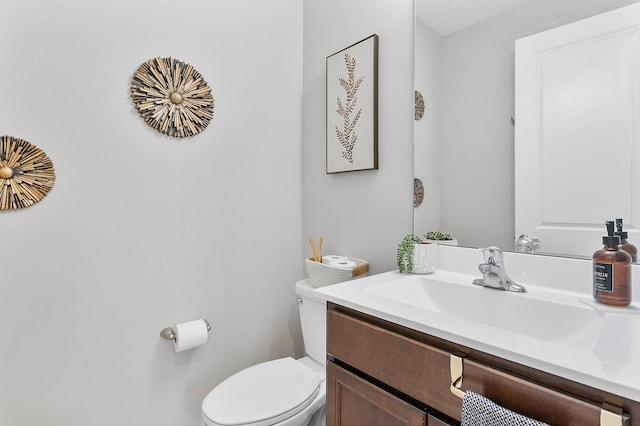 bathroom featuring toilet and vanity