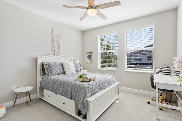 bedroom featuring ceiling fan, baseboards, and light carpet