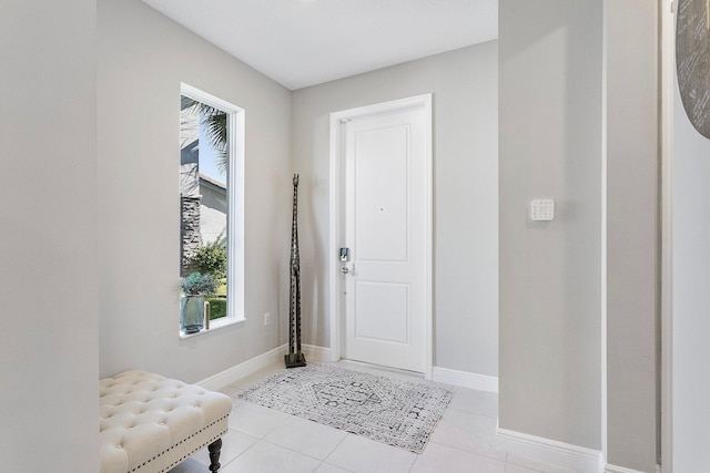 entrance foyer featuring light tile patterned floors and baseboards