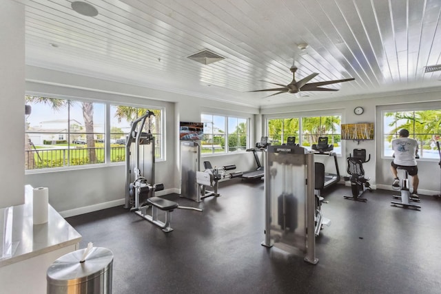 gym with plenty of natural light, baseboards, visible vents, and ornamental molding