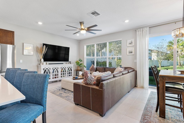 living area with light tile patterned floors, a healthy amount of sunlight, and visible vents