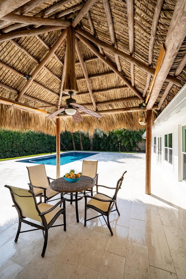 view of patio featuring a gazebo, a fenced in pool, french doors, and ceiling fan