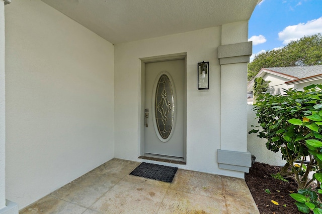 property entrance with stucco siding