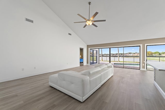 unfurnished living room featuring a healthy amount of sunlight, light wood-style floors, and ceiling fan