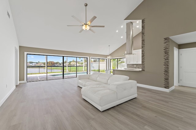 living room with baseboards, high vaulted ceiling, a ceiling fan, and light wood finished floors