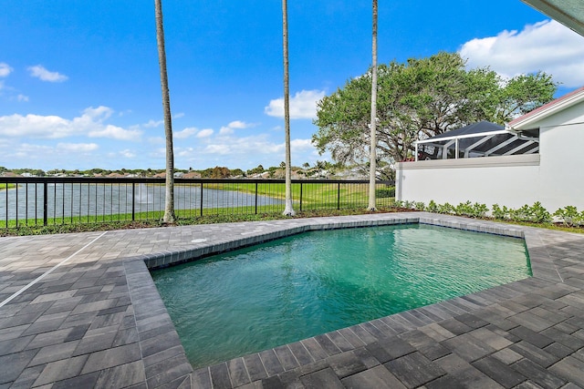 view of swimming pool with a patio area, a fenced in pool, a fenced backyard, and a water view