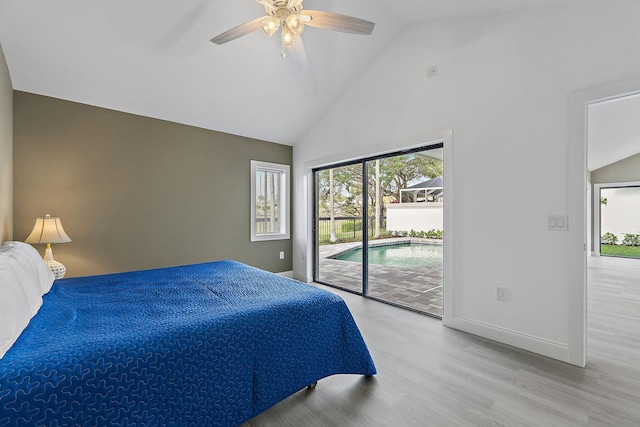 bedroom featuring baseboards, wood finished floors, high vaulted ceiling, and access to exterior