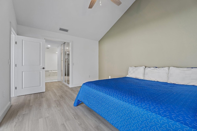 bedroom featuring vaulted ceiling, wood finished floors, visible vents, and baseboards