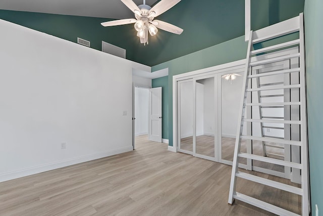 unfurnished bedroom with visible vents, baseboards, wood finished floors, a closet, and a ceiling fan