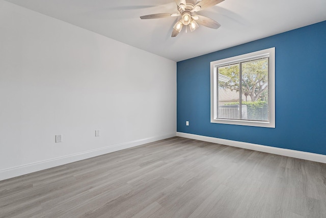 unfurnished room featuring light wood-type flooring, baseboards, and ceiling fan