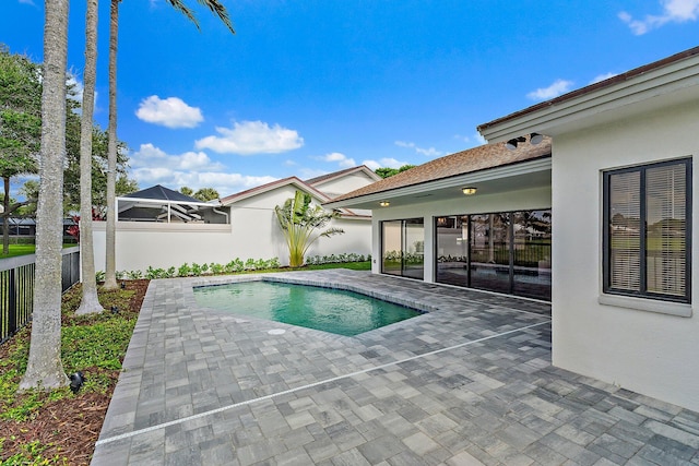 outdoor pool featuring a patio area and a fenced backyard