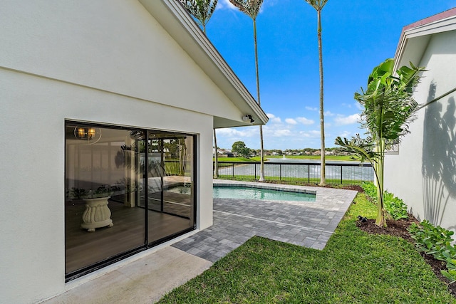 exterior space with a fenced in pool, a water view, a patio, and fence