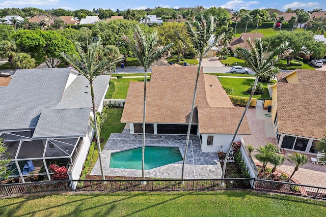 view of swimming pool with a lanai, a residential view, a fenced backyard, and a patio