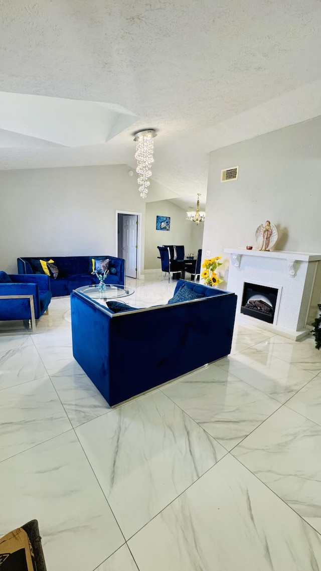 living room featuring visible vents, a notable chandelier, marble finish floor, a textured ceiling, and lofted ceiling