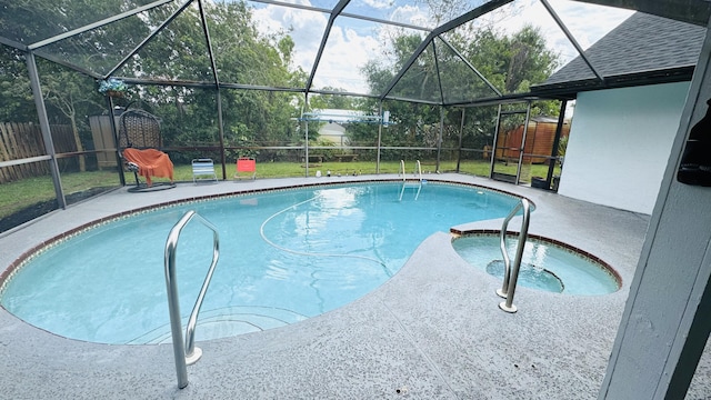 view of pool featuring a pool with connected hot tub, a patio, a fenced backyard, glass enclosure, and a yard