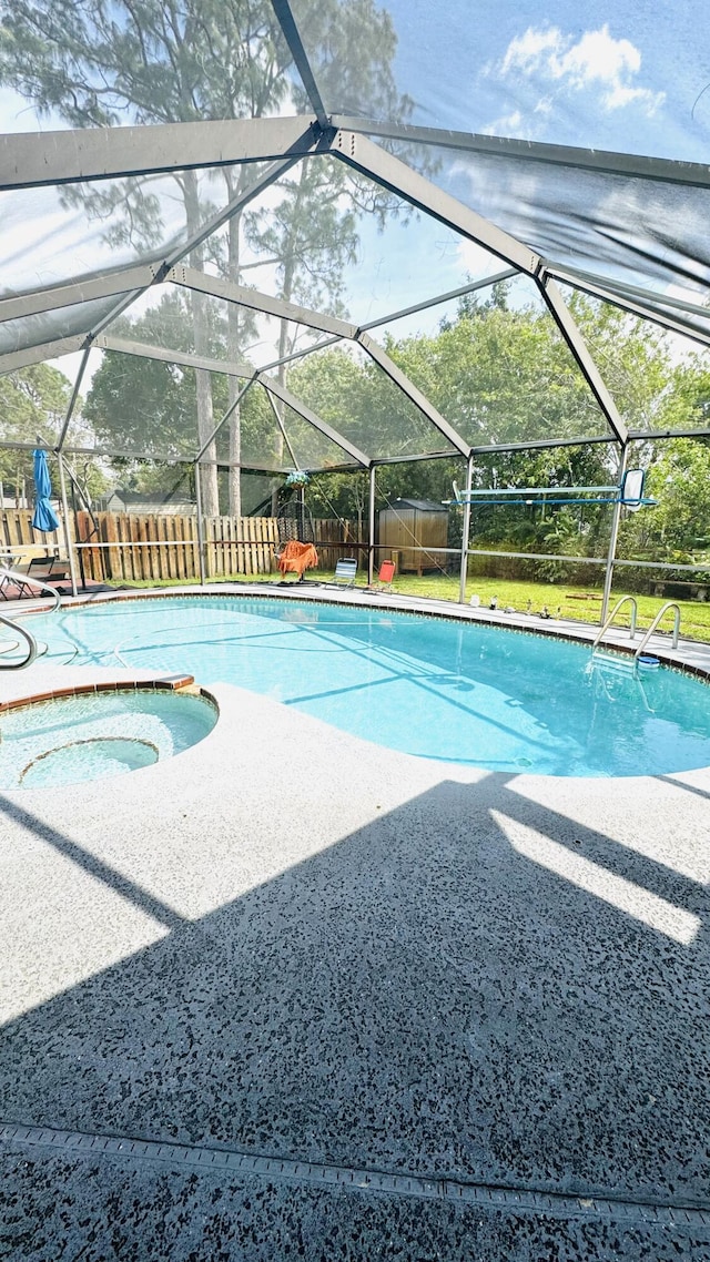 view of pool featuring a fenced backyard, a fenced in pool, an in ground hot tub, a lanai, and a patio area