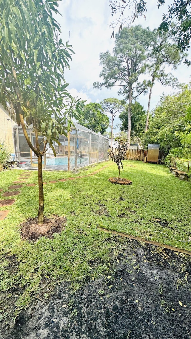 view of yard with fence and a fenced in pool