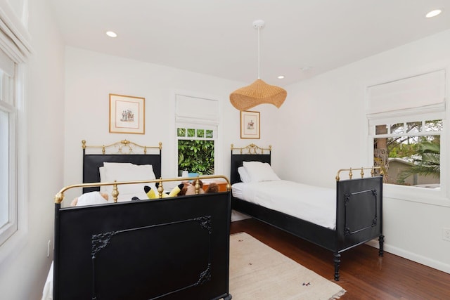 bedroom with recessed lighting, baseboards, and wood finished floors