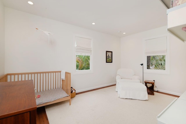 bedroom featuring wood finished floors, recessed lighting, and baseboards