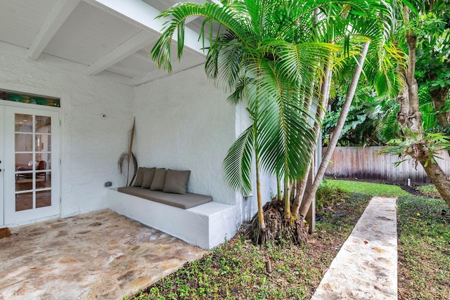 exterior space featuring a patio area, stucco siding, and fence