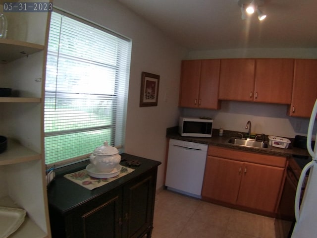 kitchen featuring a sink, open shelves, white appliances, and dark countertops