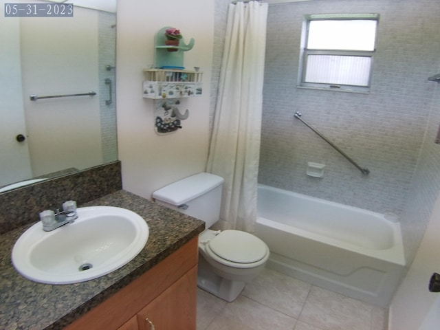 full bath featuring tile patterned floors, shower / tub combo with curtain, vanity, and toilet