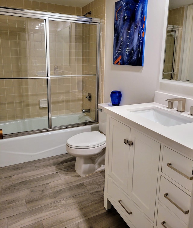 13321 Polo Club Rd Unit C103, Wellington, FL 33414 - full bathroom featuring vanity, toilet, wood finished floors, and bath / shower combo with glass door