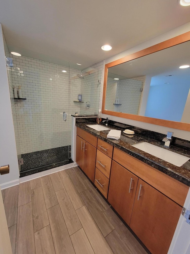 13321 Polo Club Rd Unit C103, Wellington, FL 33414 - full bath featuring a shower stall, wood finish floors, double vanity, and a sink