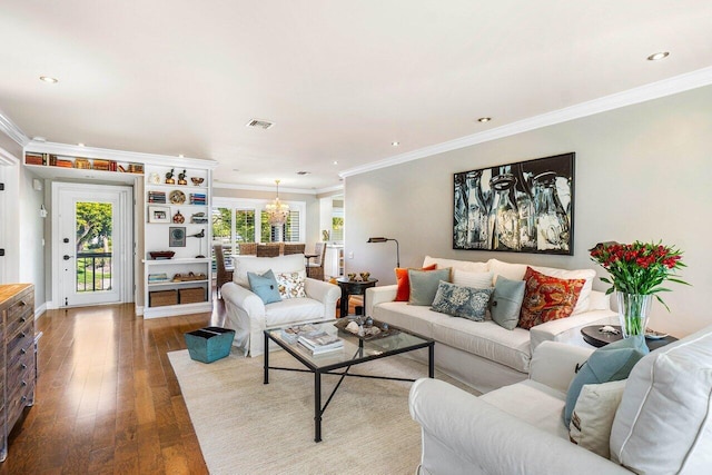 living room with hardwood / wood-style flooring, visible vents, and ornamental molding