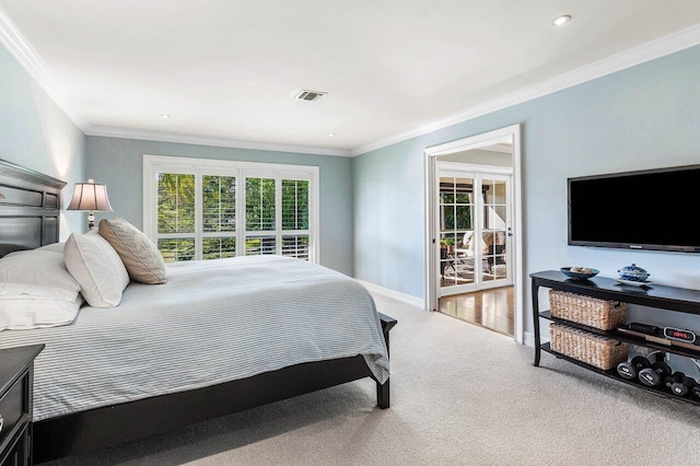 carpeted bedroom with crown molding, multiple windows, baseboards, and visible vents