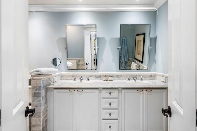 bathroom featuring a sink, double vanity, and crown molding