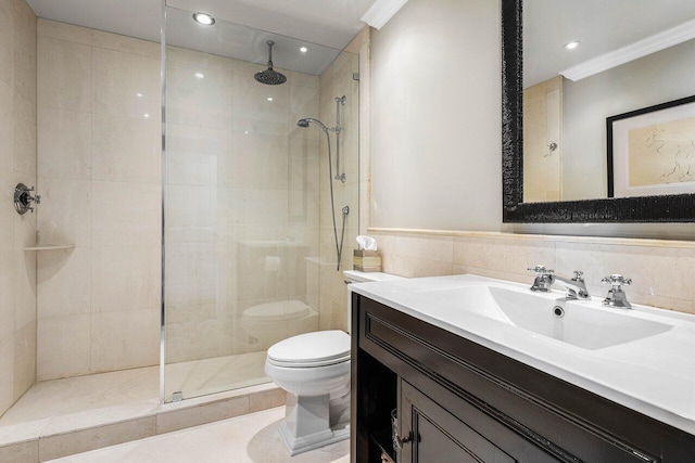 bathroom featuring vanity, tiled shower, crown molding, toilet, and tile walls