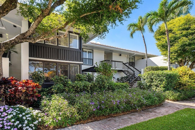 exterior space featuring stucco siding and stairs