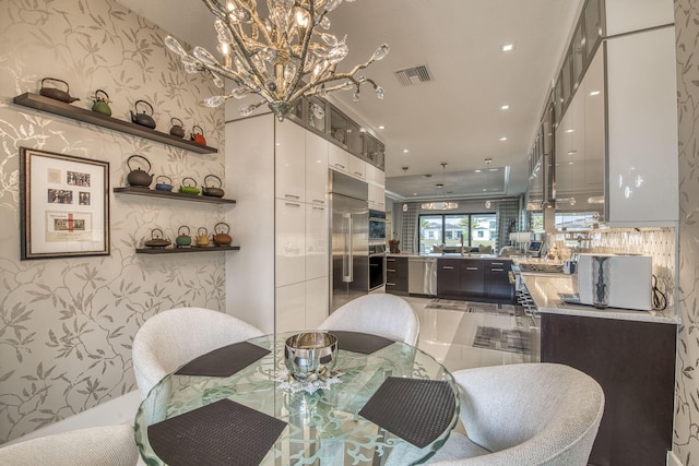 dining area with wallpapered walls, a notable chandelier, recessed lighting, and visible vents