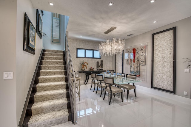 dining area with stairway, visible vents, an inviting chandelier, recessed lighting, and a textured ceiling