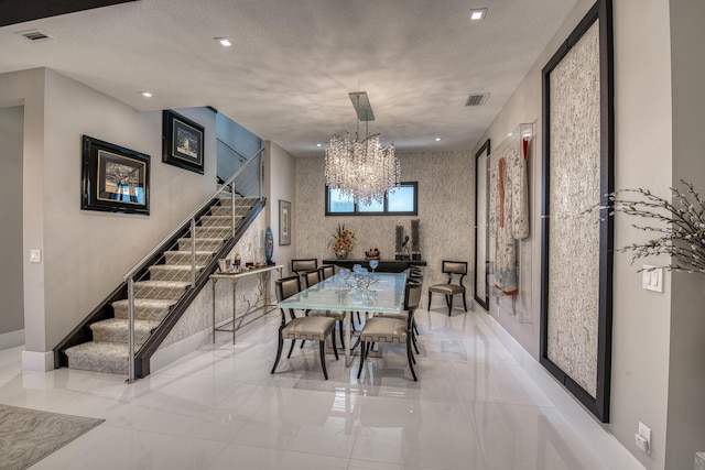 dining area featuring a textured ceiling, recessed lighting, an inviting chandelier, baseboards, and stairs