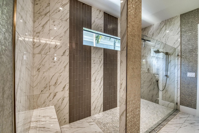 full bath with a marble finish shower and marble finish floor