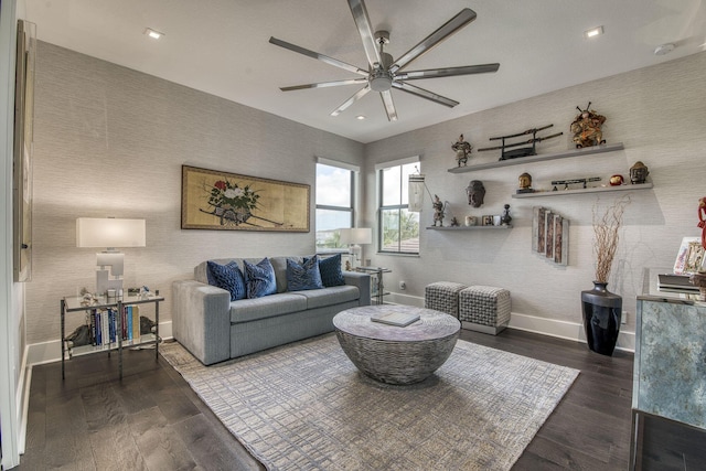 living room with baseboards, wood finished floors, and wallpapered walls