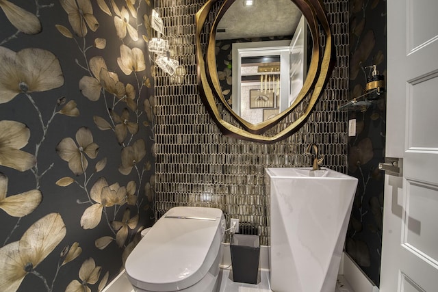 bathroom with toilet and a sink