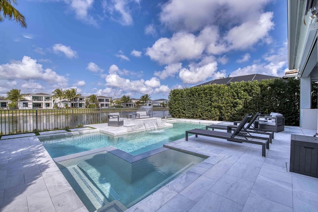 view of pool with a patio, fence, a residential view, and a pool with connected hot tub