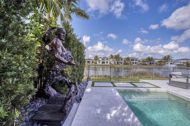 view of pool featuring a fenced in pool, a water view, fence, a residential view, and a patio area