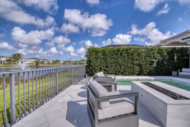 view of patio with a water view and a hot tub