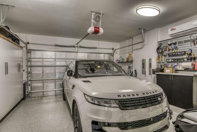 garage featuring a wall mounted air conditioner and a garage door opener