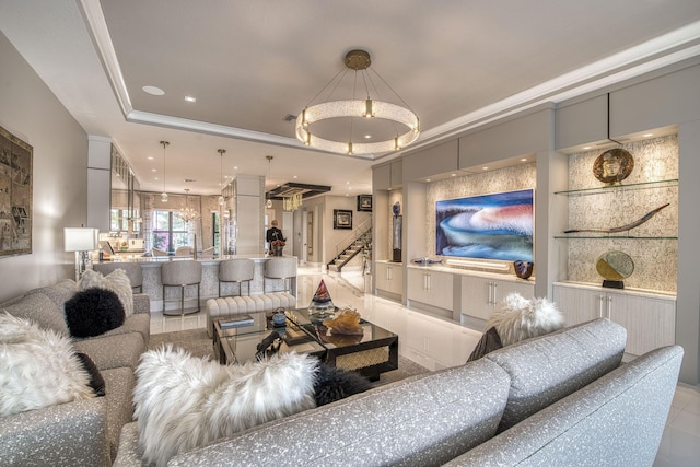 living room with a tray ceiling, stairs, and crown molding