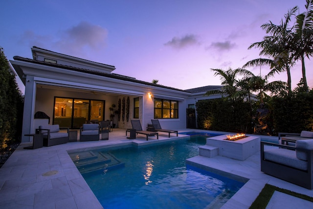 exterior space with an outdoor living space with a fire pit, a patio, a ceiling fan, and an outdoor pool