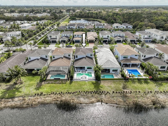 birds eye view of property with a residential view and a water view