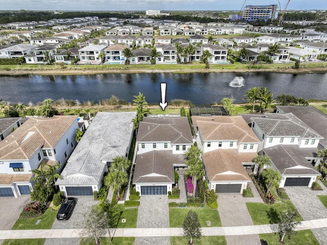 birds eye view of property with a residential view and a water view