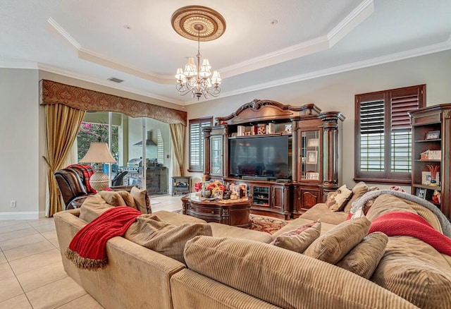 living area with tile patterned floors, visible vents, an inviting chandelier, crown molding, and a raised ceiling