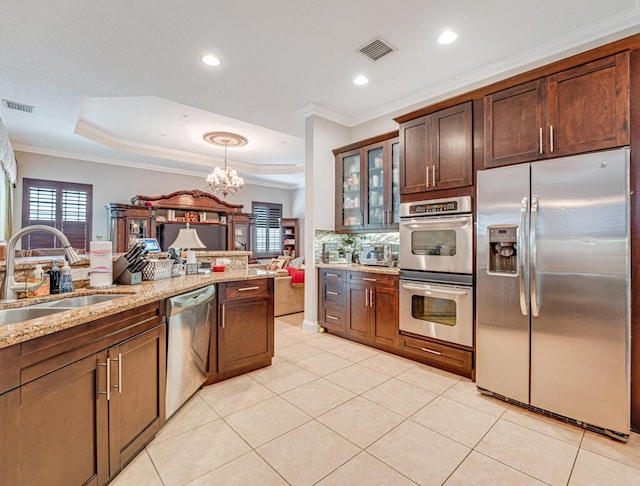 kitchen featuring a sink, a raised ceiling, visible vents, and stainless steel appliances